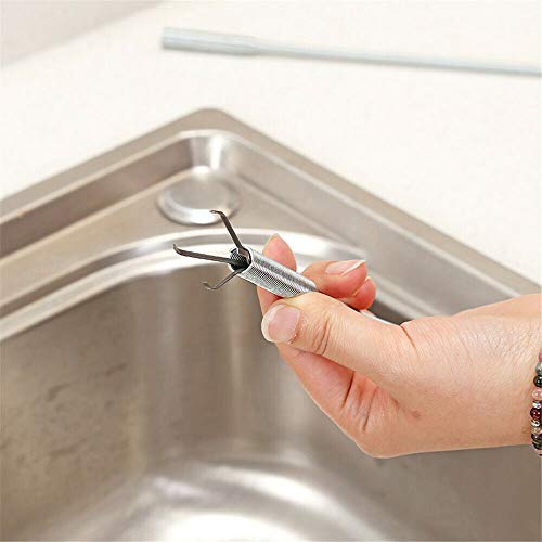 DRILAX drain cleaning tool flexible grabber stainless steel claw held over kitchen sink