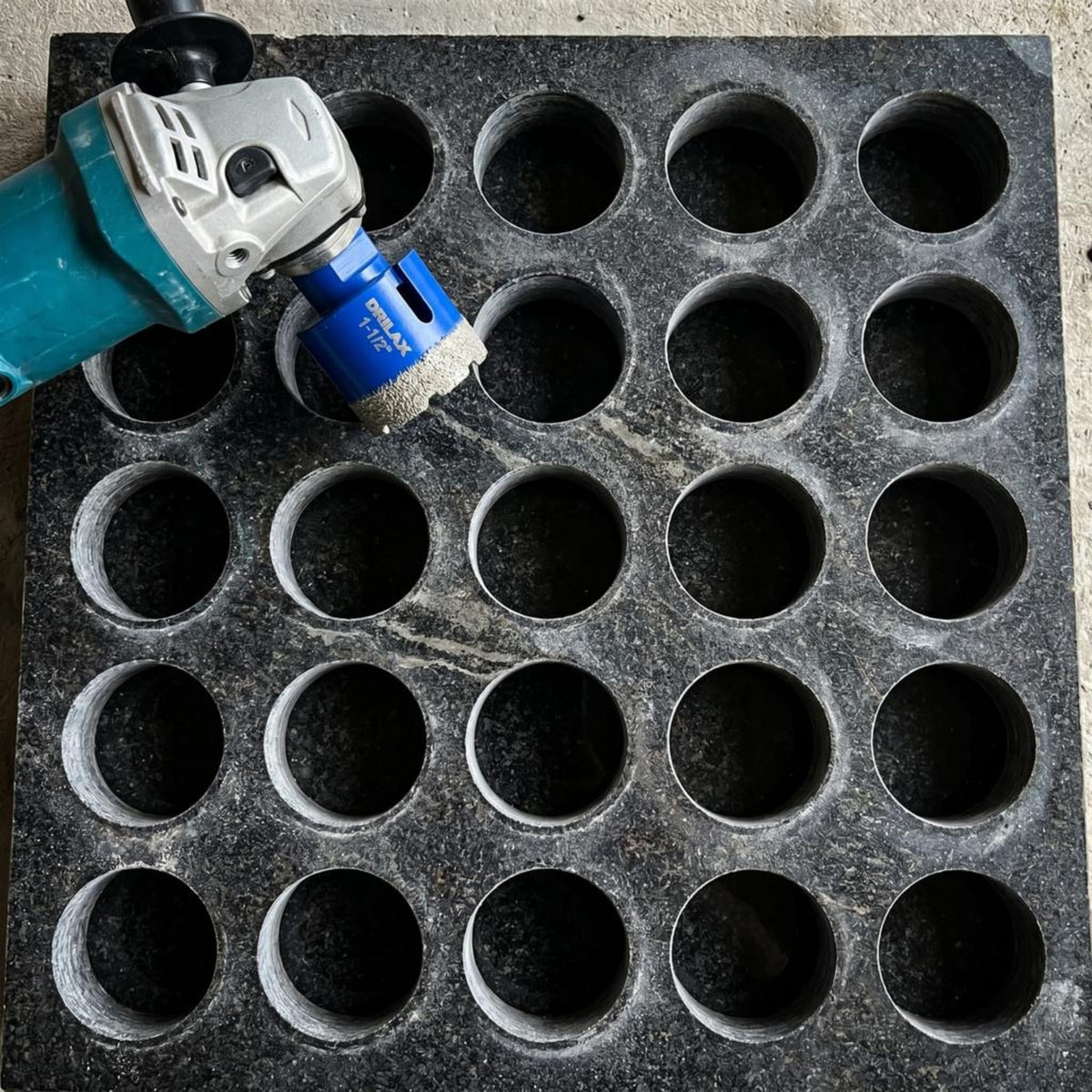 Rows of clean holes drilled in a stone slab