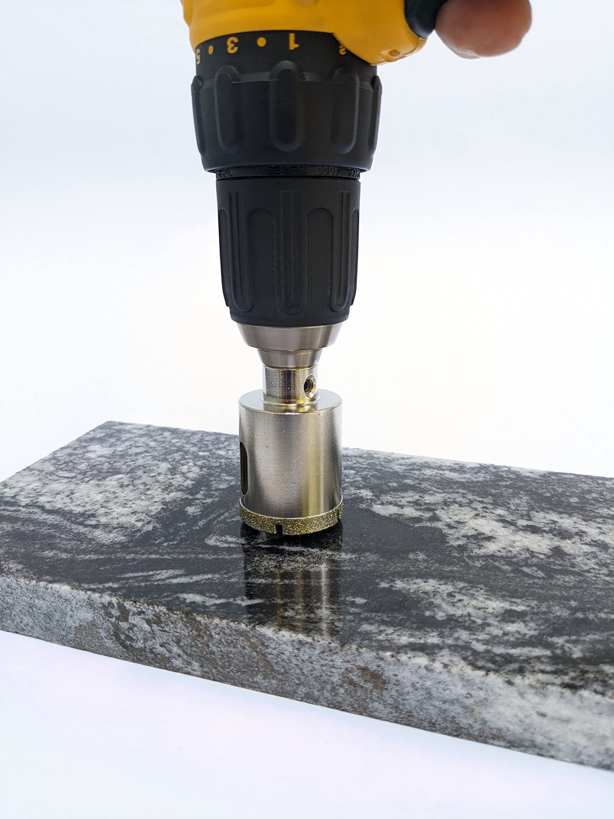 Drilling straight down into granite with the 1-3/8 inch diamond hole saw