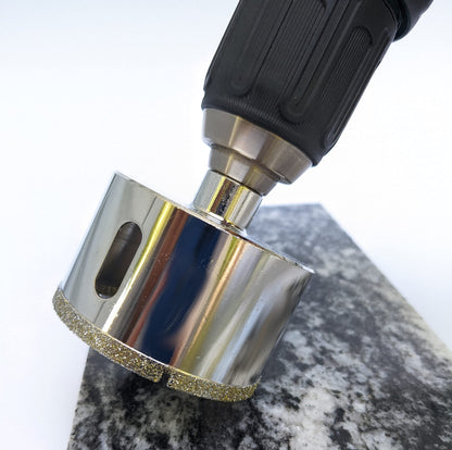Drilling stone with the 2-1/2 inch diamond hole saw on a cordless drill