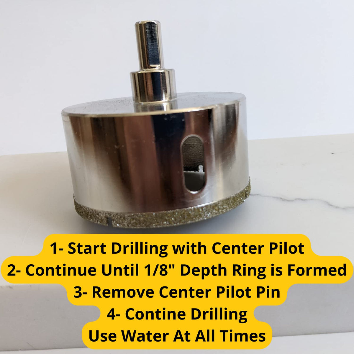 Steps: start with the center pilot, cut a 1/8 inch ring, remove the pilot pin, continue drilling with water
