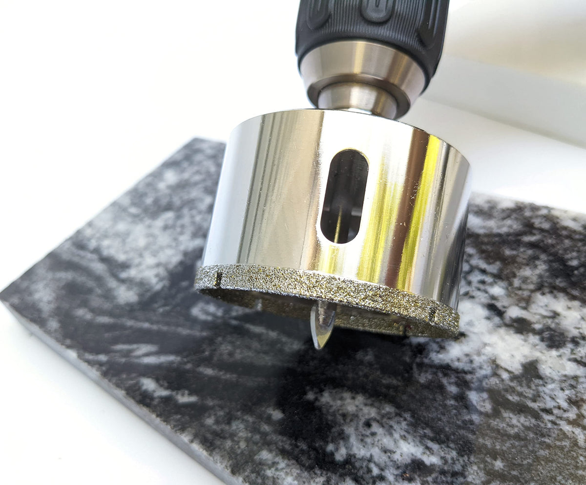 2-1/2 inch diamond hole saw starting a cut in a marble slab