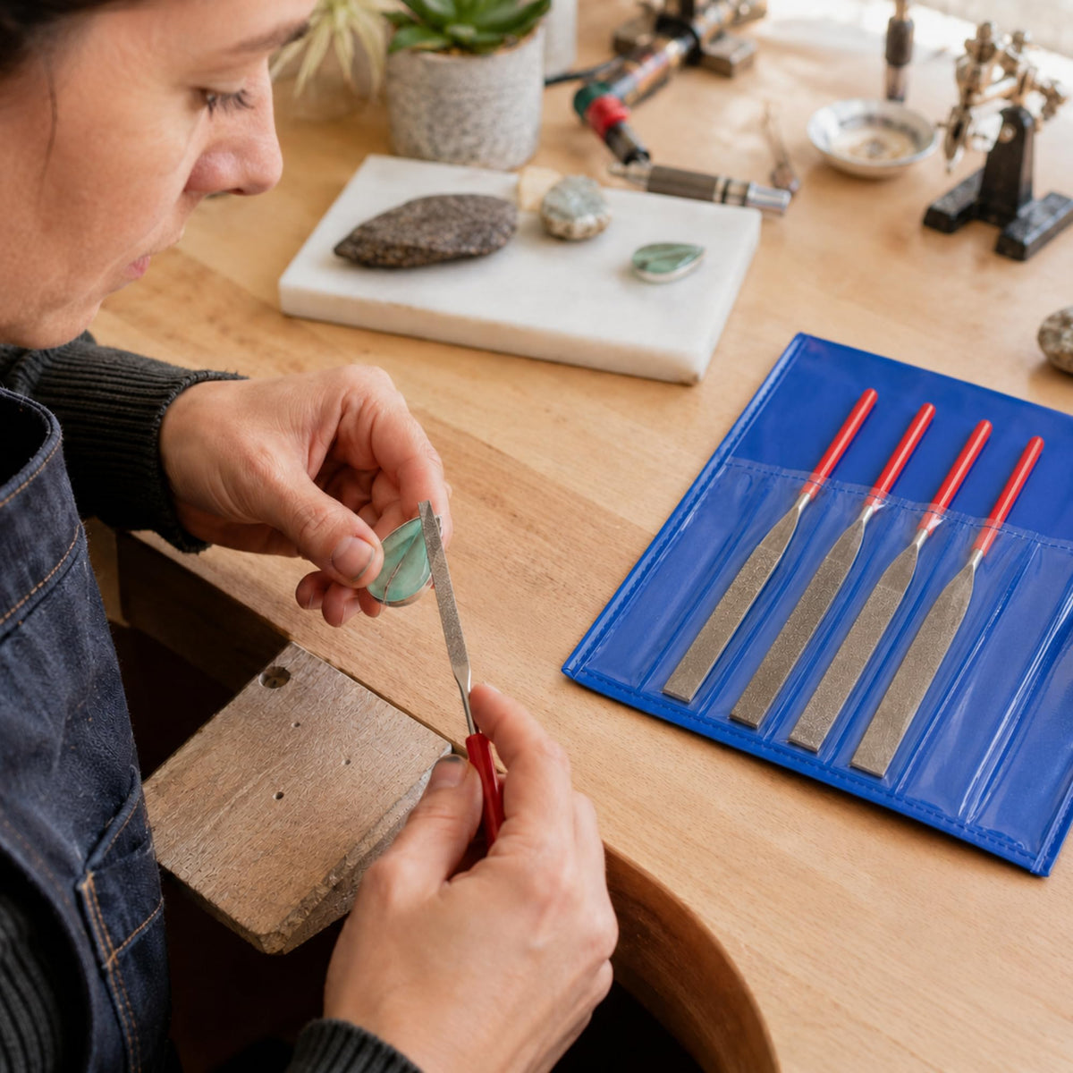 Diamond flat file shaping a stone at a workbench
