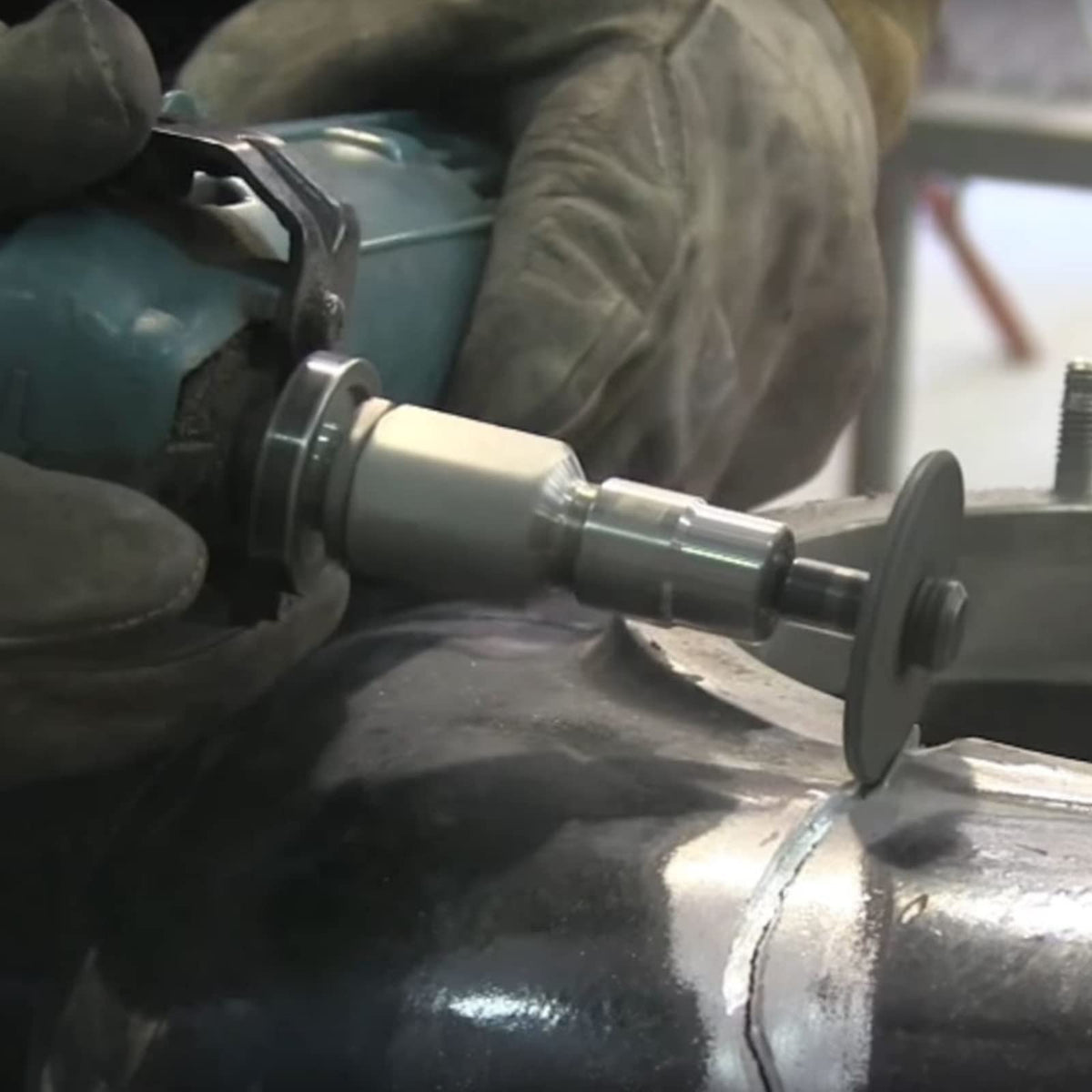 Flapper adapter with a small cutoff wheel working a weld on steel pipe